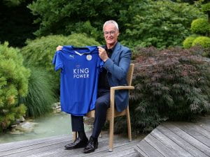 Ranieri che tiene in mano una maglietta del Leicester.